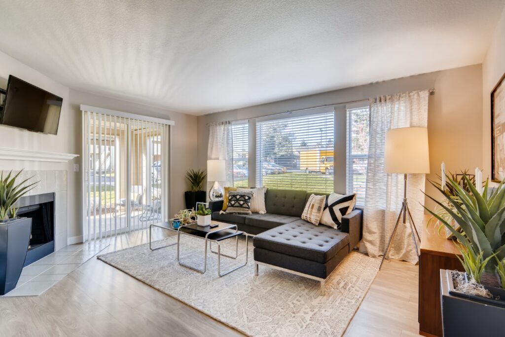 Living room with large windows, glass patio doors, and fire place