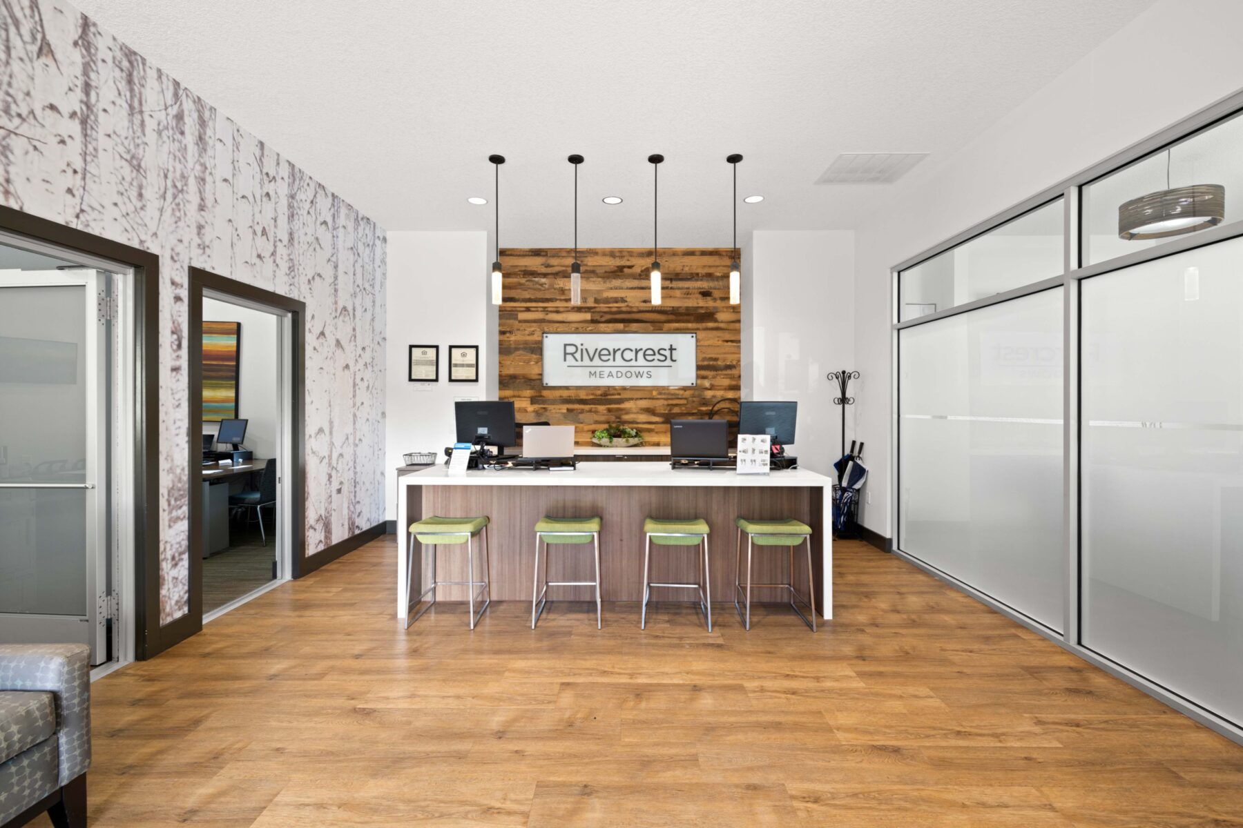 Leasing office lobby with reception desk and private offices