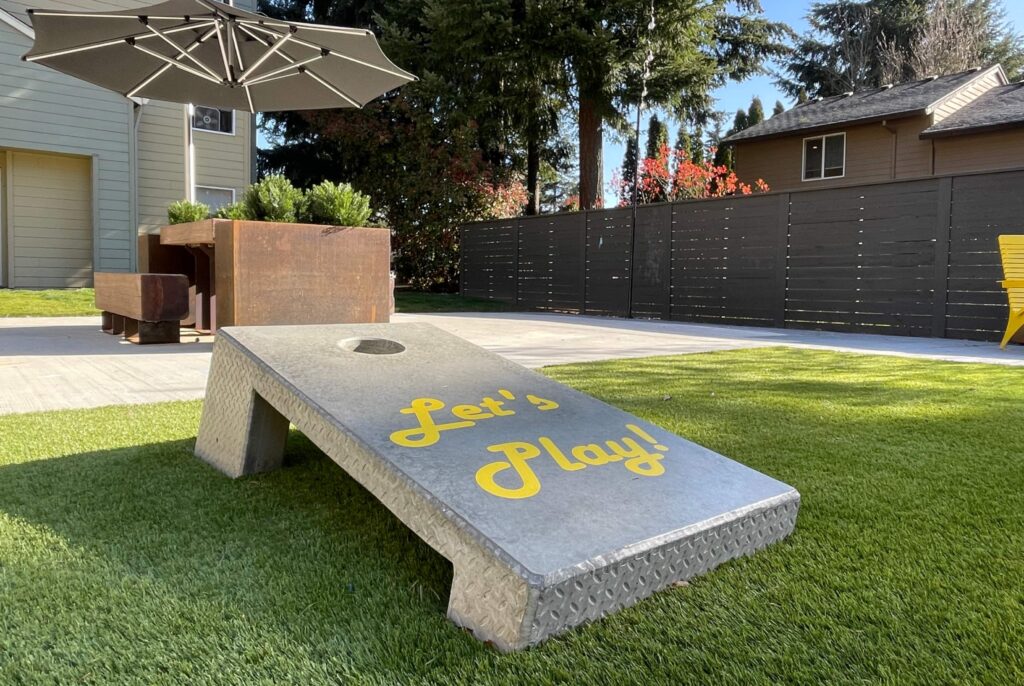 corn hole game in a grassy area