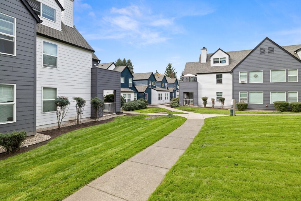 Sidewalks and grassy lawns in between residential buildings